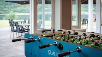 A foosball table with the text "QUALITY HOTEL" in the center.