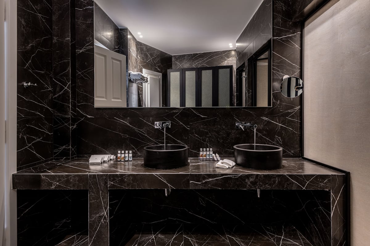 suite (mystery) | bathroom | shower, free toiletries, hair dryer, bathrobes