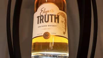 A bottle of Edgar's Truth Southern Whiskey in a wooden chair.