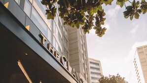 A modern building with a prominent entrance and a sign that reads "THE CLANCY". -  The Clancy, Autograph Collection by Marriott (San Francisco)