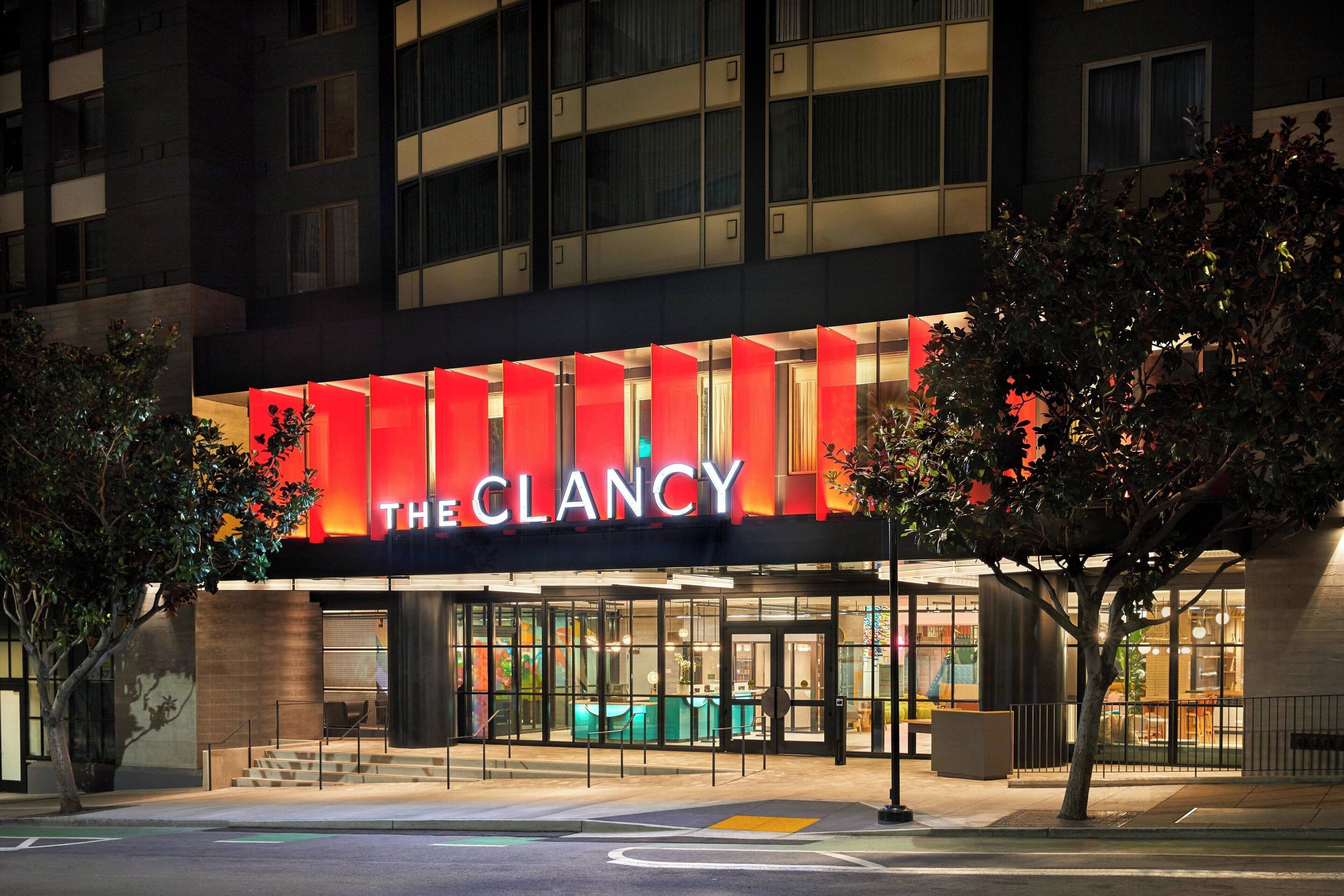 A hotel entrance with a prominent red sign reading "THE CLANCY".