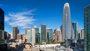 A cityscape with modern skyscrapers, a prominent curved building, and a bridge.