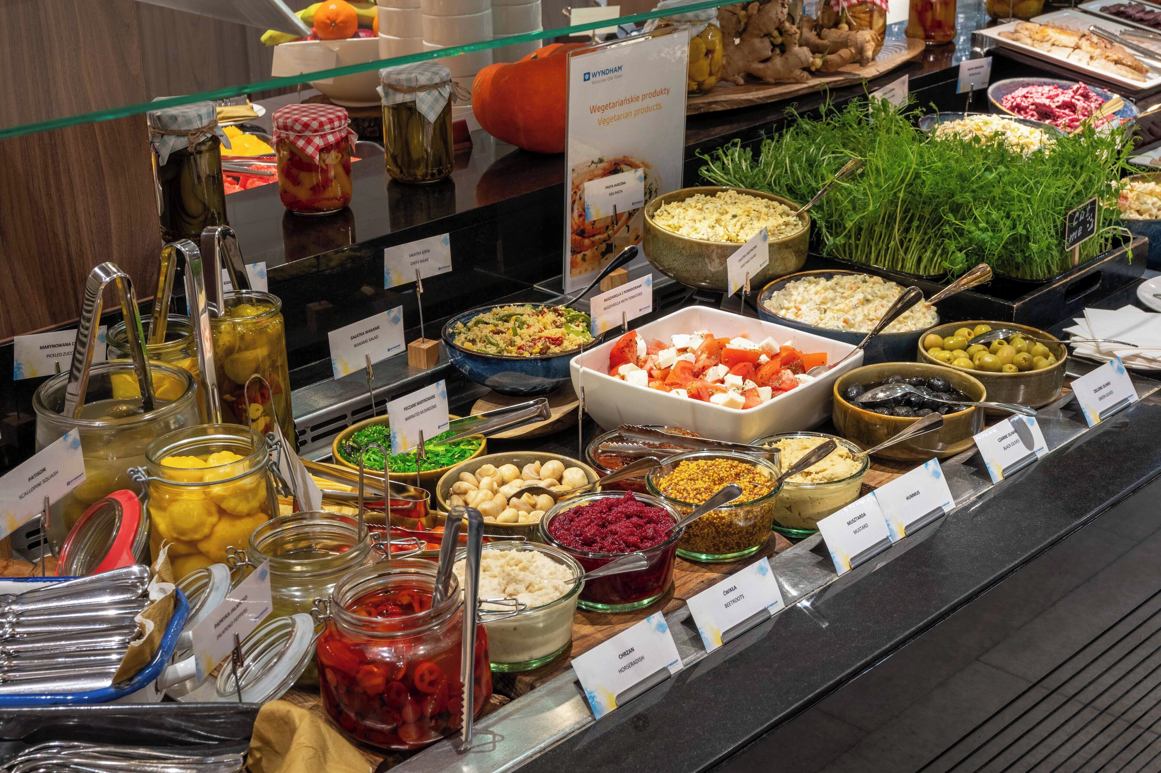 A buffet with various food items and condiments.