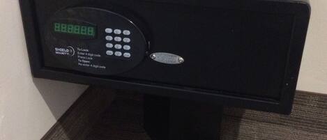 Et sort, elektronisk pengeskab med digitalt tastatur og vejledning til låsning og oplåsning.