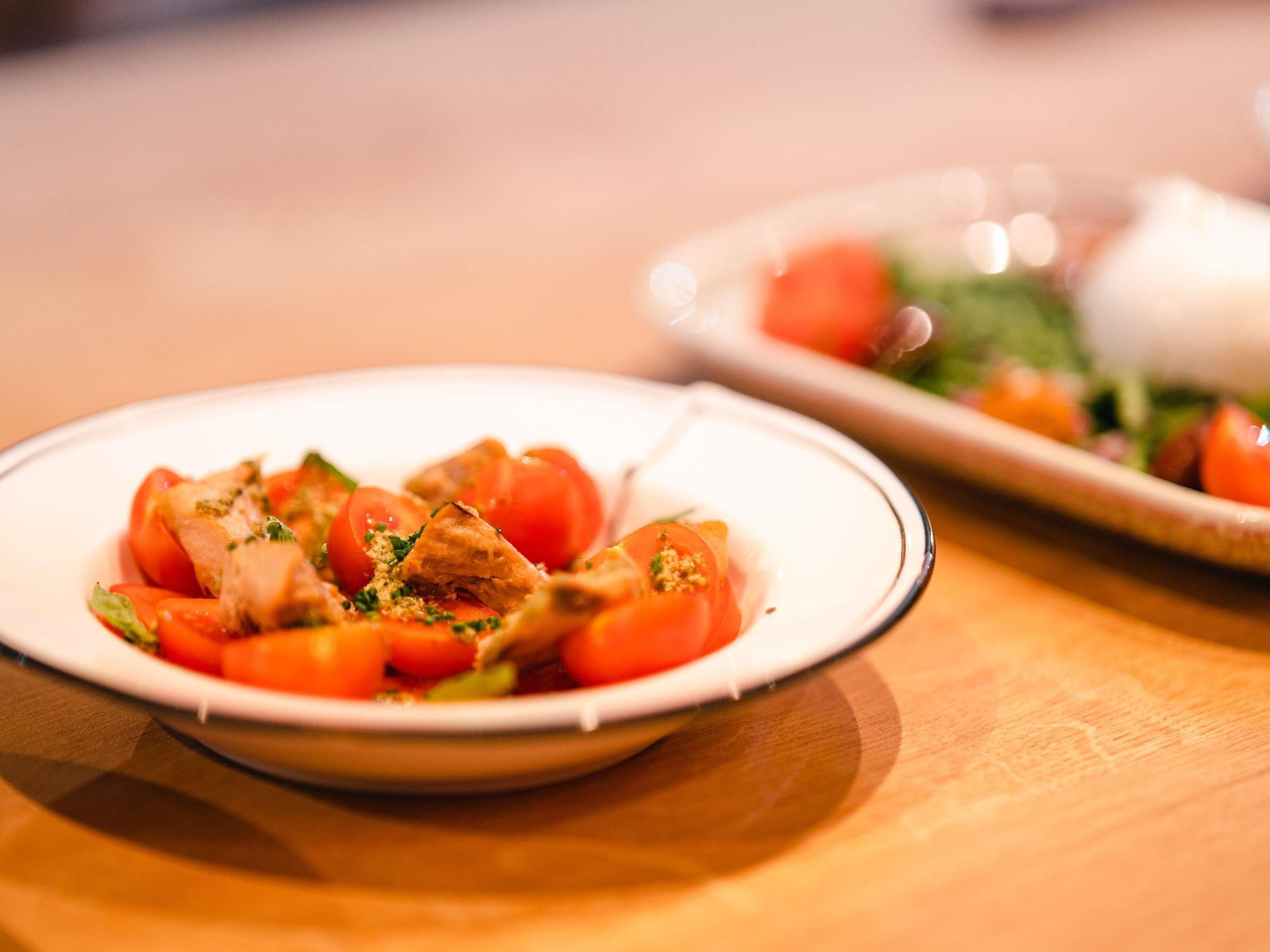 Un plato de comida con tomates y un tenedor.