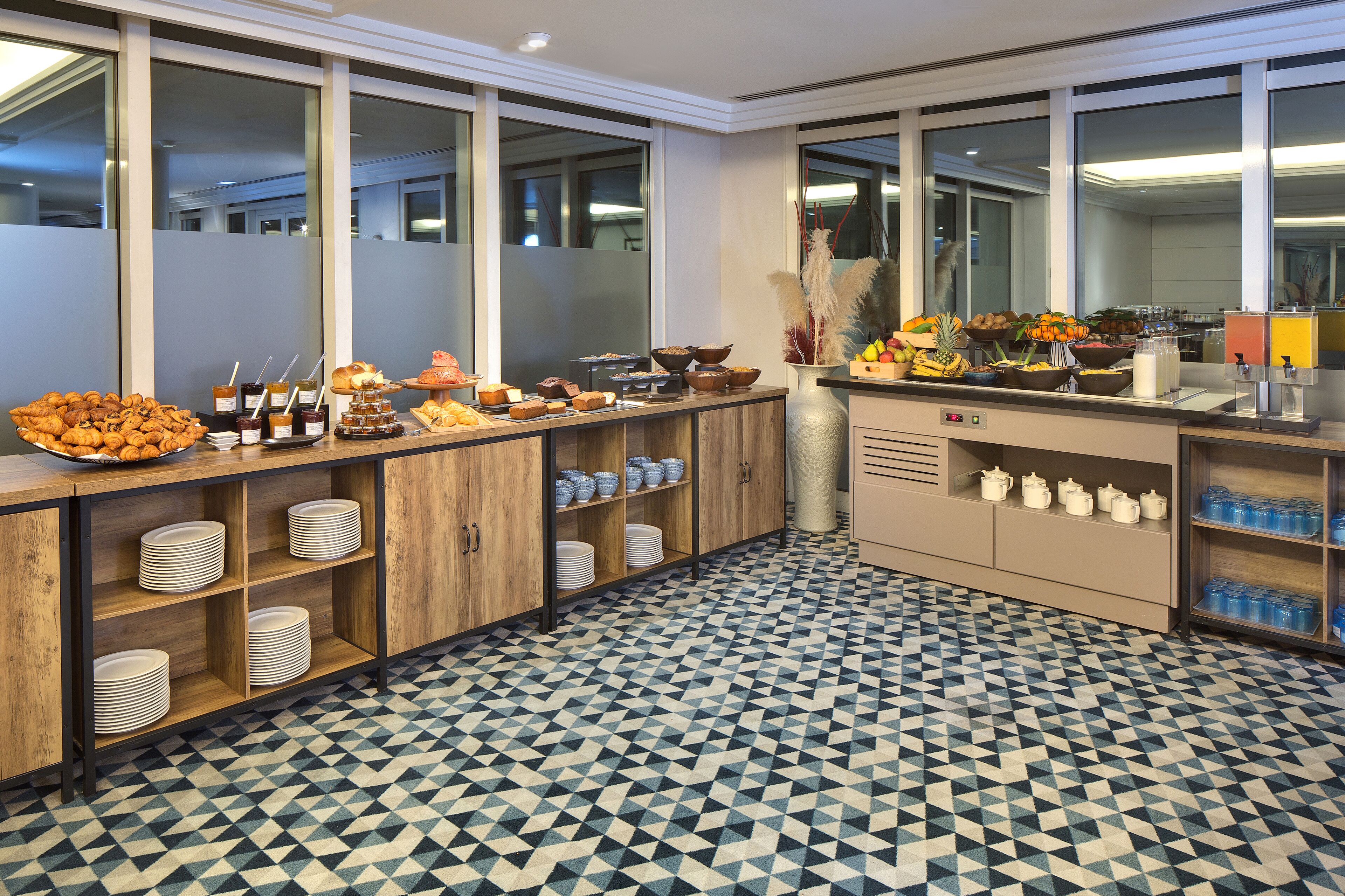 A buffet setup with various food items and serving dishes.