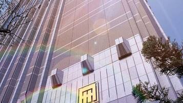 A tall building with a sign for 'AMBASSADOR Hsinhchu'.