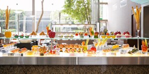 A buffet with various food items and drinks, including sushi, salads, and fruit. - Ambassador Hotel - Hsinchu (Hsinchu)