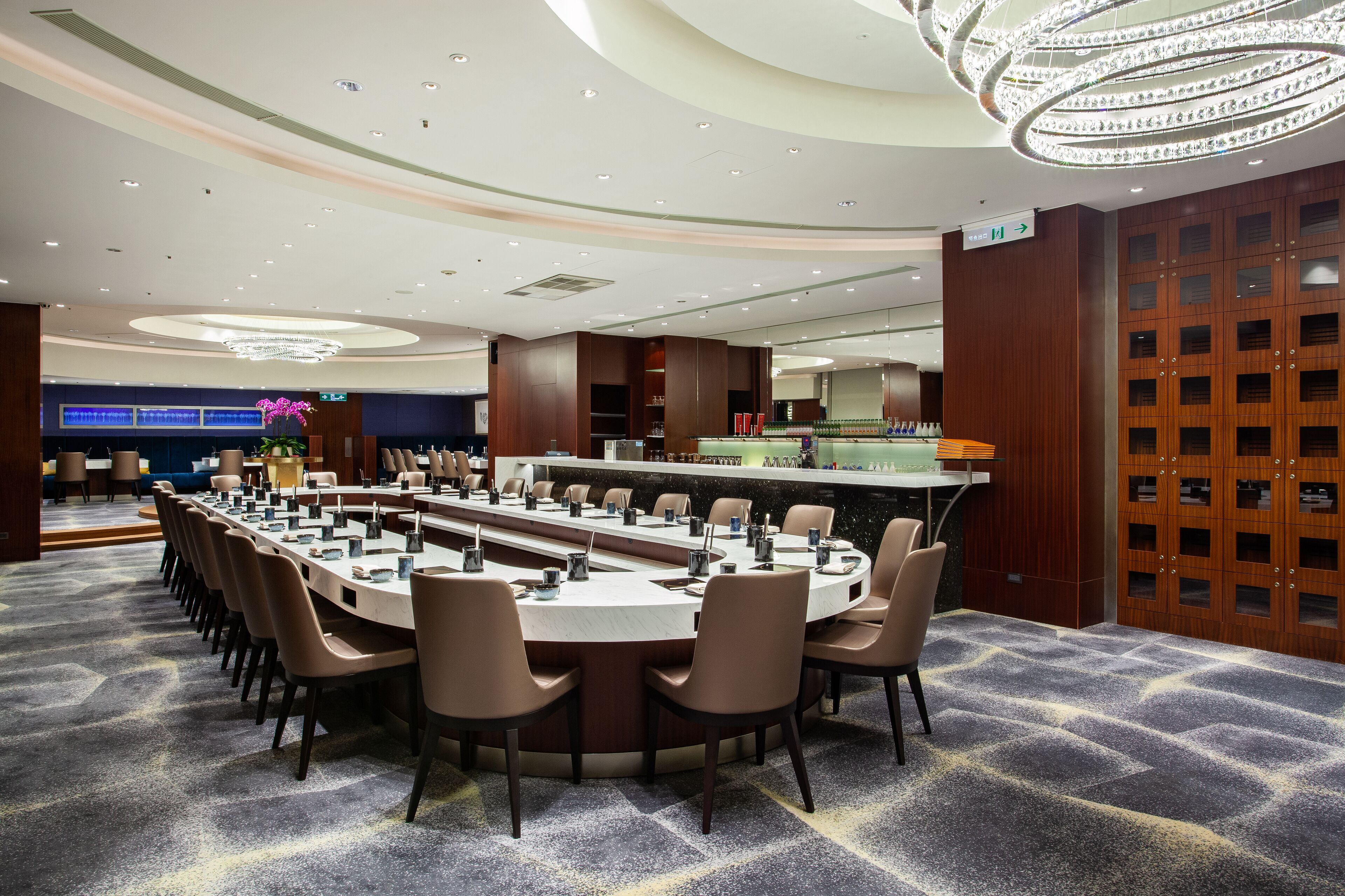 A conference room with a long table, chairs, and a bar area.