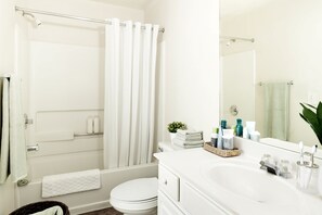 Combined shower/bathtub, towels, soap, toilet paper