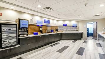A modern kitchen area with a self-serve station for yogurt, eggs, and milk.
