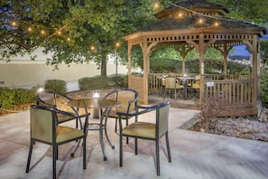 An outdoor patio with a gazebo, tables, and chairs. - Holiday Inn Express & Suites Longview North by IHG (Longview)