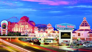 A brightly lit casino complex with multiple buildings, including a prominent hotel and casino named "Buffalo Bill's."