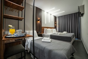 A hotel room with two beds, a desk with a tray of breakfast, a chair, and a TV mounted on the wall. - Argo Hotel (Piraeus)