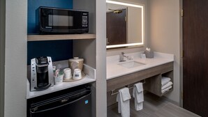 A modern bathroom with a microwave, coffee maker, and sink. - Holiday Inn Express Charleston-Kanawha City by IHG (Charleston)