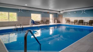 An indoor swimming pool with clear water, a lifeguard chair, and a bench. - Holiday Inn Express Charleston-Kanawha City by IHG (Charleston)