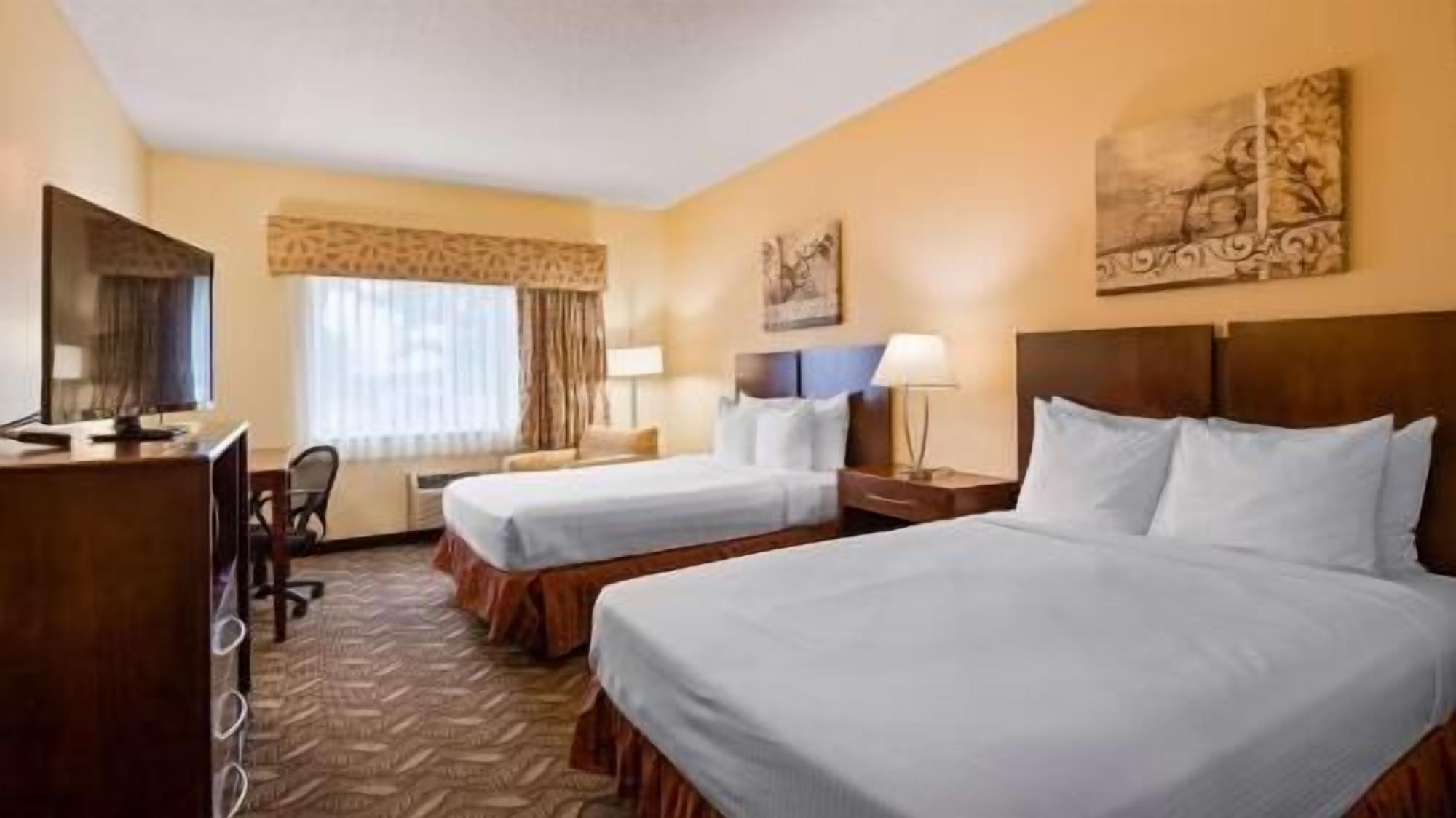 Hypo-allergenic bedding, desk, laptop workspace, blackout drapes