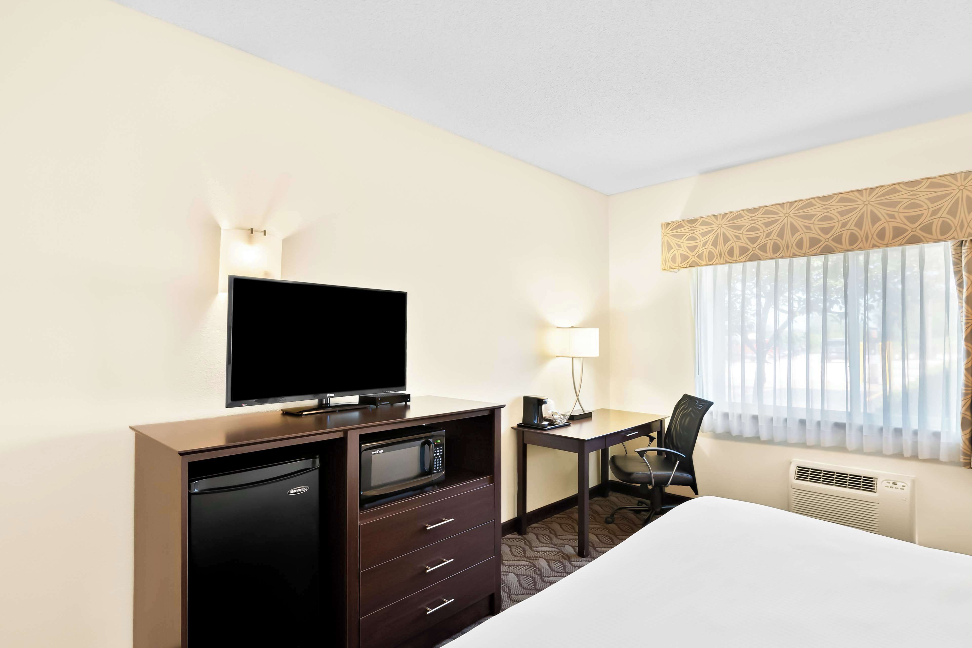 hypo-allergenic bedding, desk, laptop workspace, blackout curtains