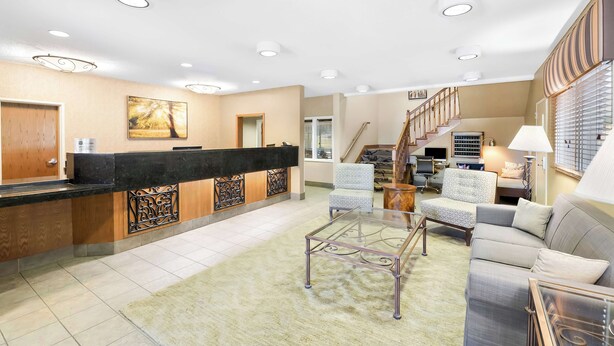 A spacious living area with a reception desk, a staircase, a sofa, and a coffee table. - Best Western Nebraska City Inn (Nebraska City)