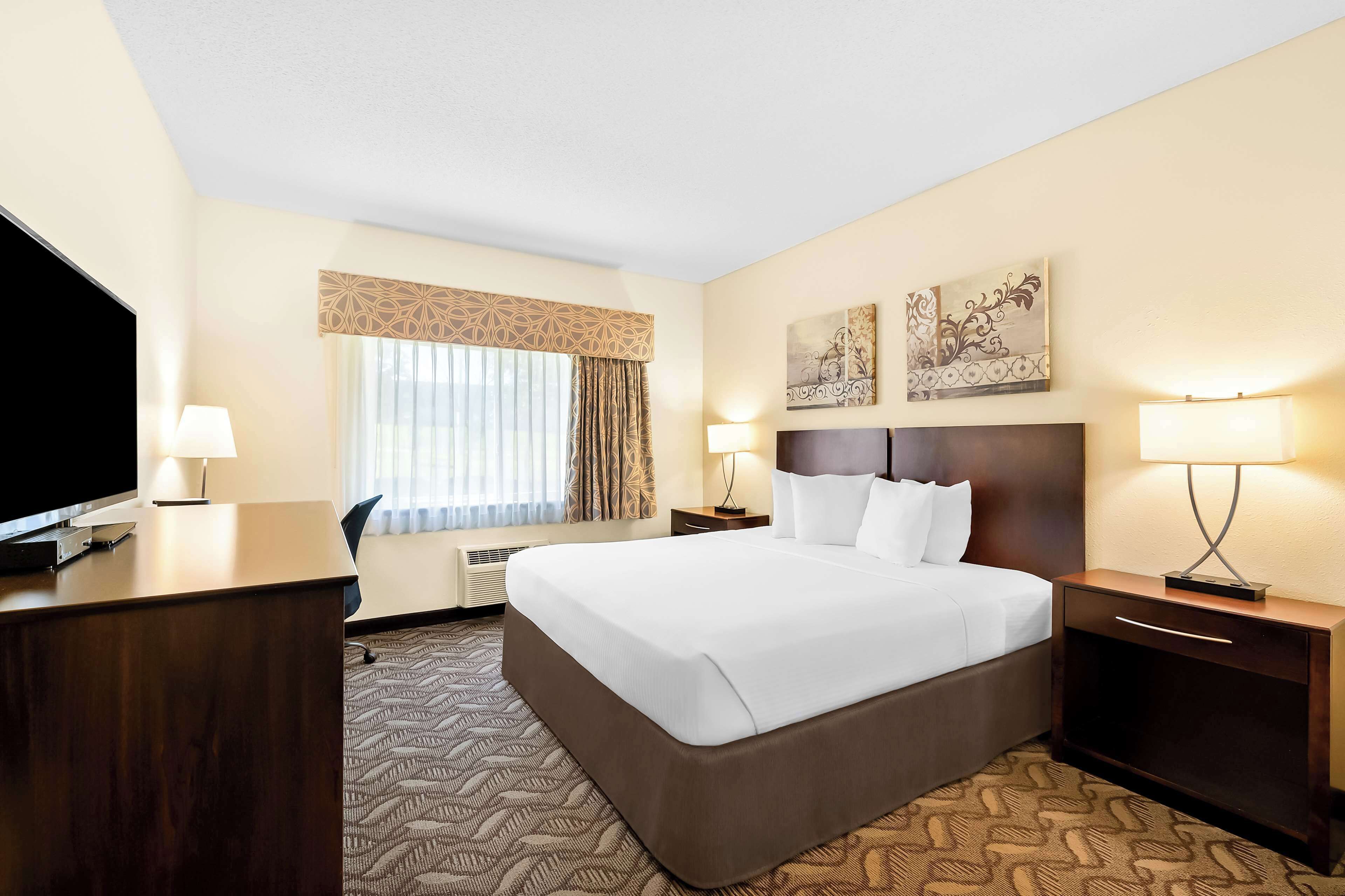 hypo-allergenic bedding, desk, laptop workspace, blackout curtains