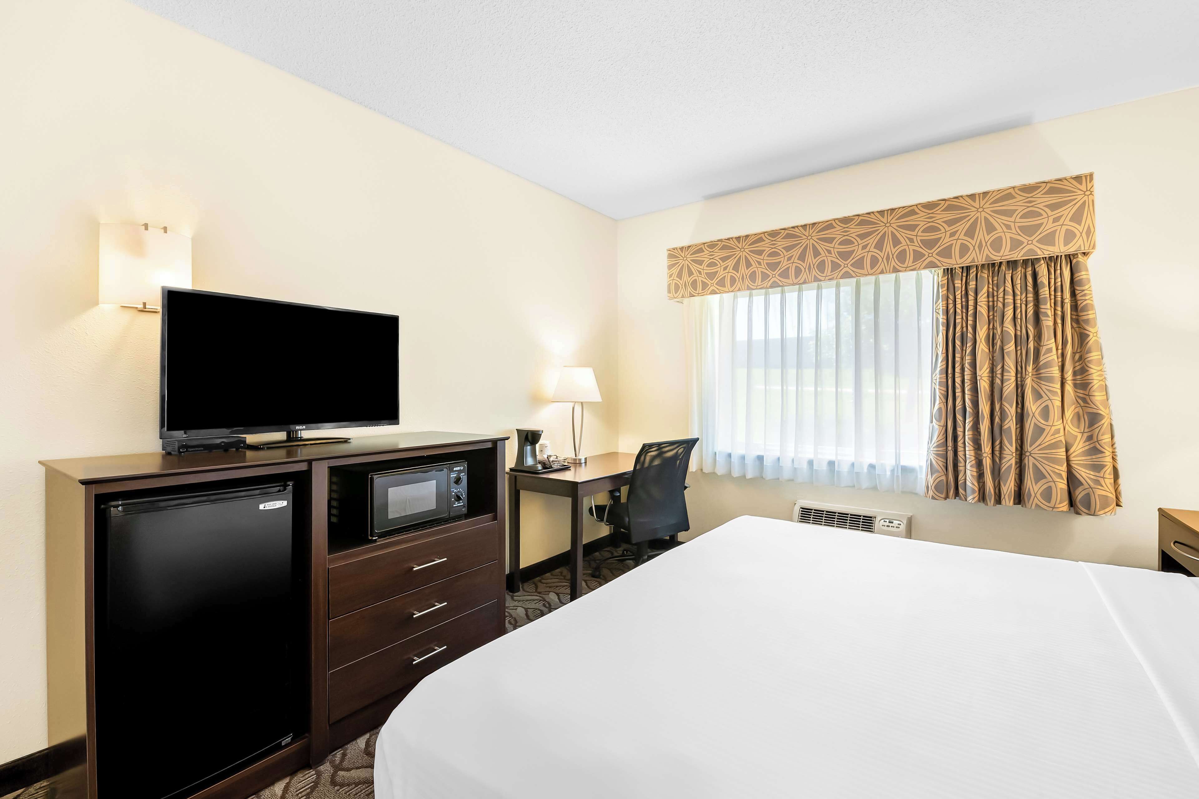 hypo-allergenic bedding, desk, laptop workspace, blackout curtains