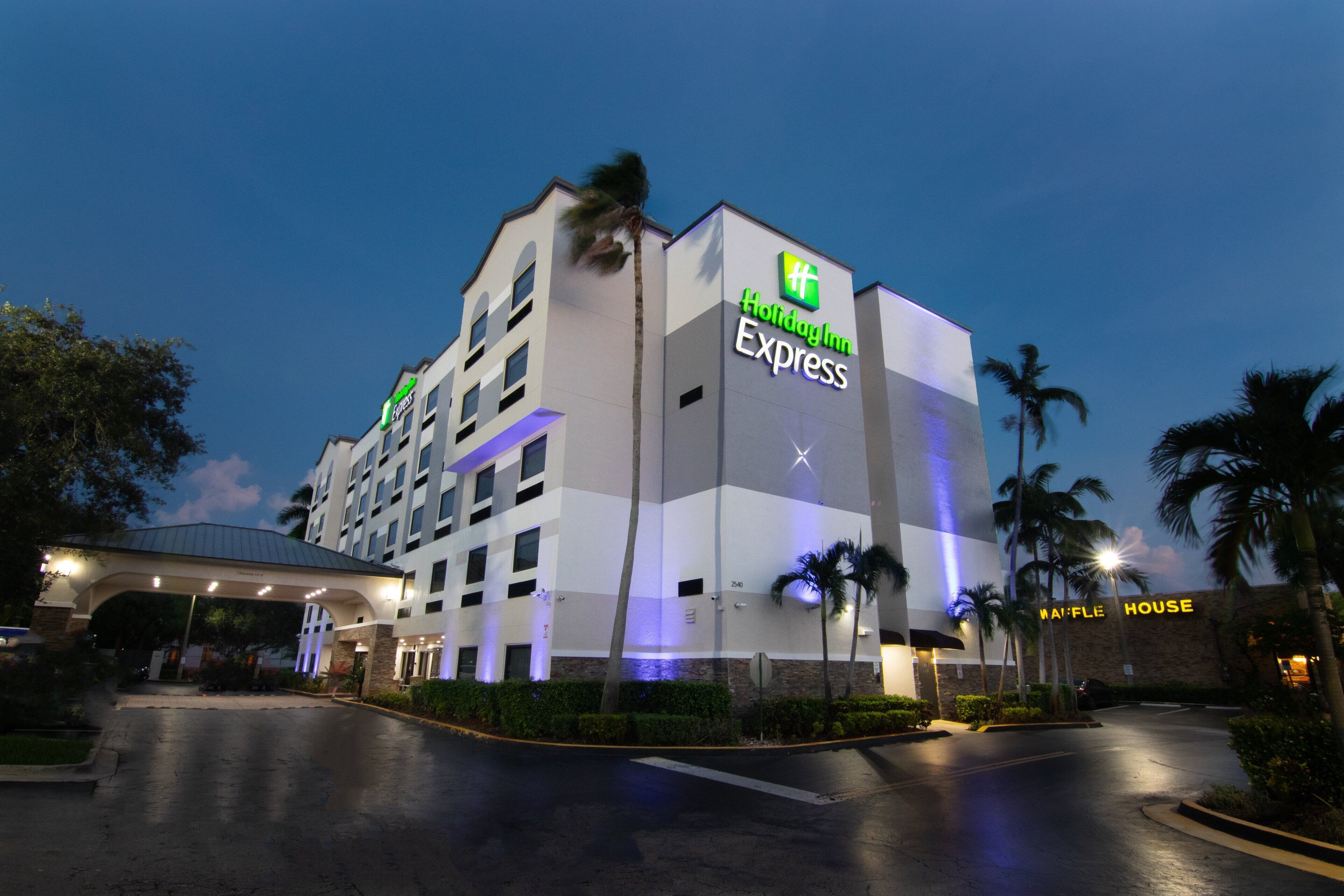 A Holiday Inn Express building with a modern design, featuring a prominent 'Holiday Inn Express' sign on the facade.