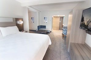 A hotel room with a large bed, a desk, a chair, and a TV. - Holiday Inn Express & Suites Ft. Lauderdale Airport West by IHG (Davie)