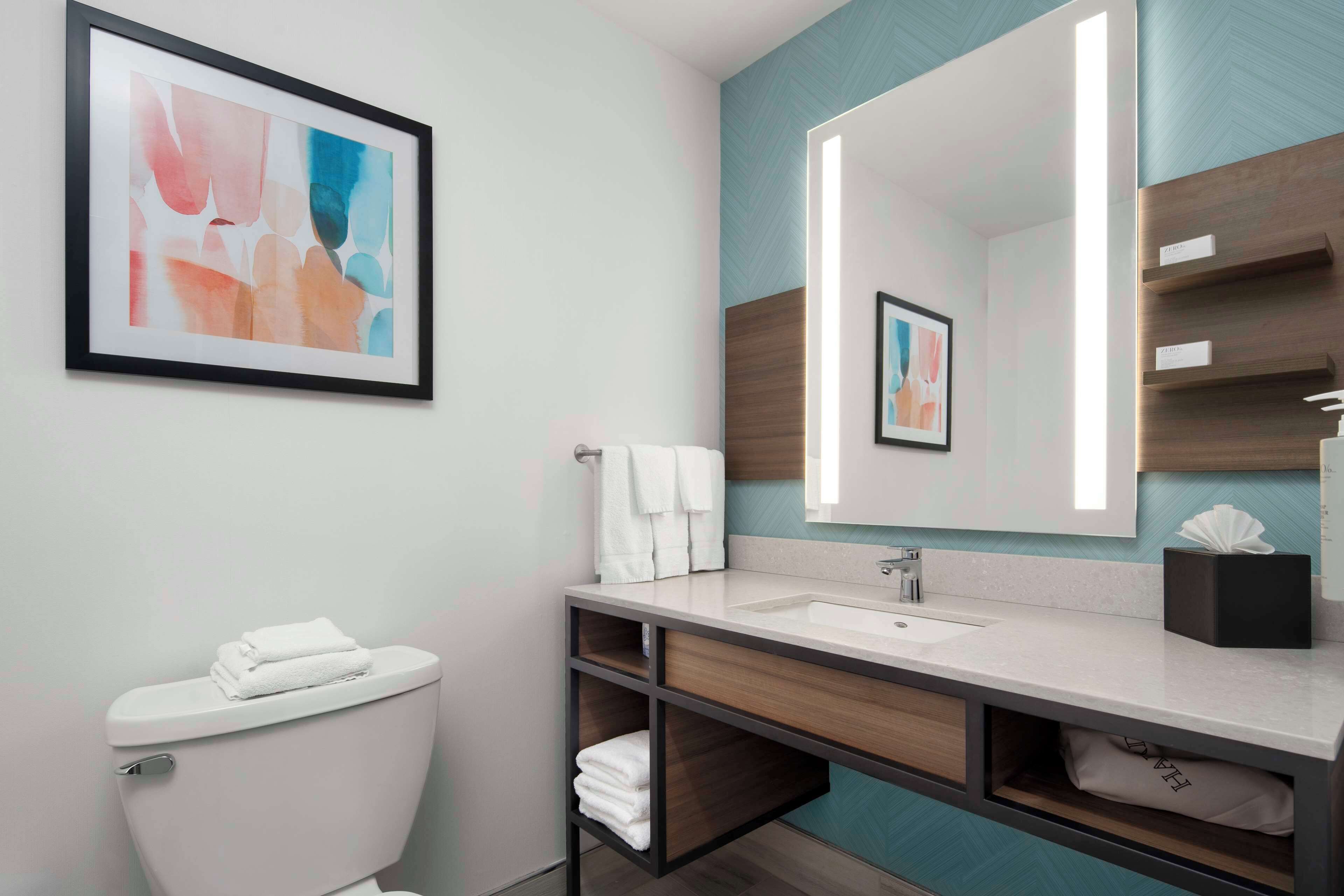 designer toiletries, hair dryer, towels