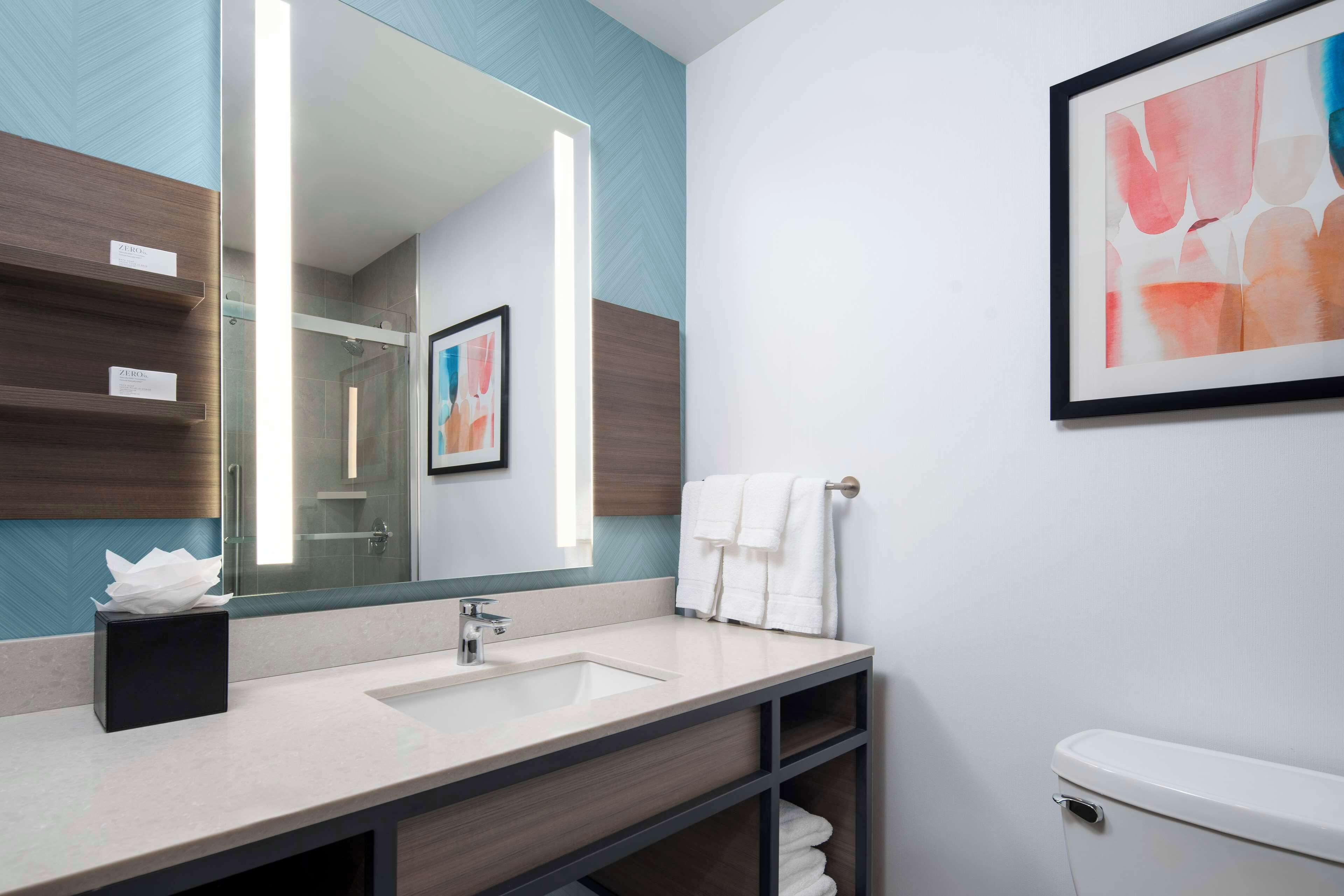 designer toiletries, hair dryer, towels