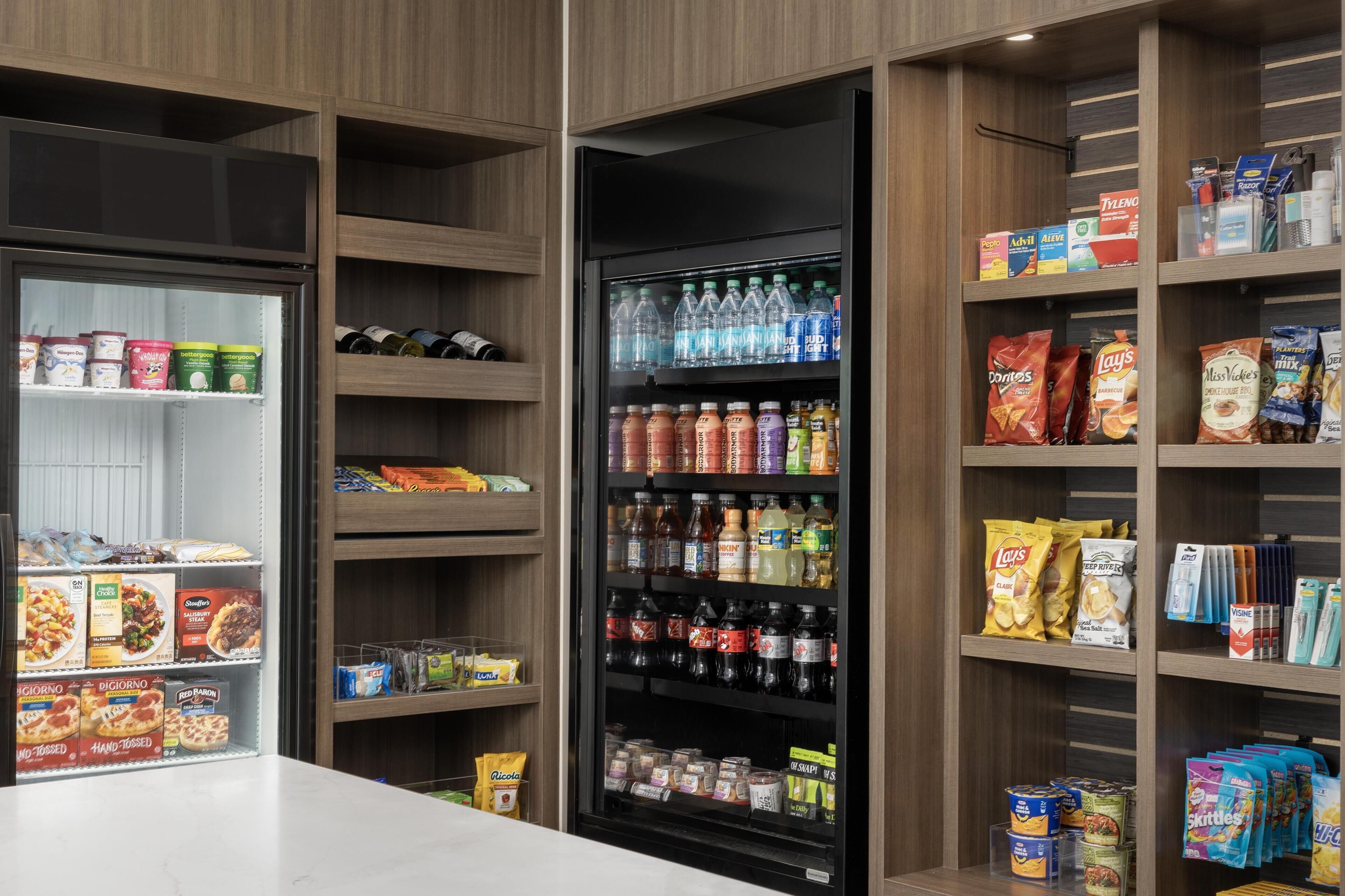 A refrigerated display with various food items and beverages.