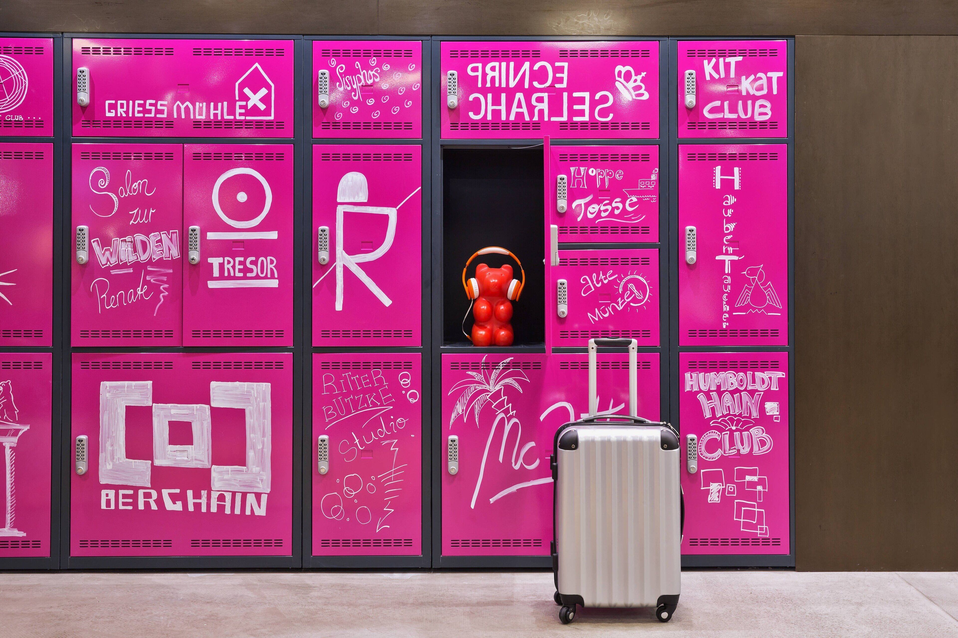 A row of lockers with various labels such as "CRIESS MUHLER," "SERENCH," and "KIT KAT CLUB."
