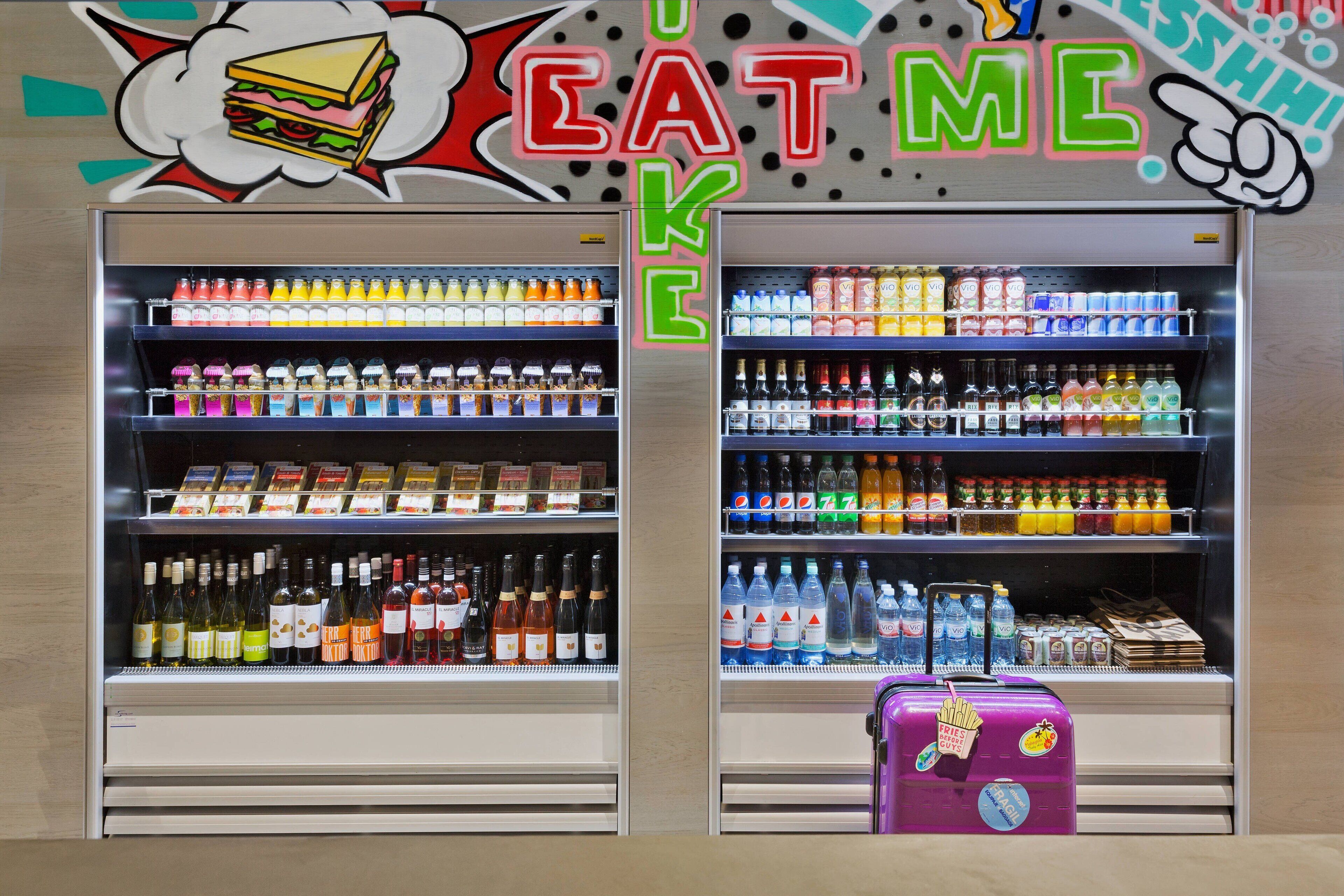 A vending machine with a variety of beverages and snacks, including bottled water, sodas, and juices.