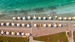 An aerial view of a beach with rows of umbrellas and sun loungers. - Rodos Palace Hotel (Rhodes)