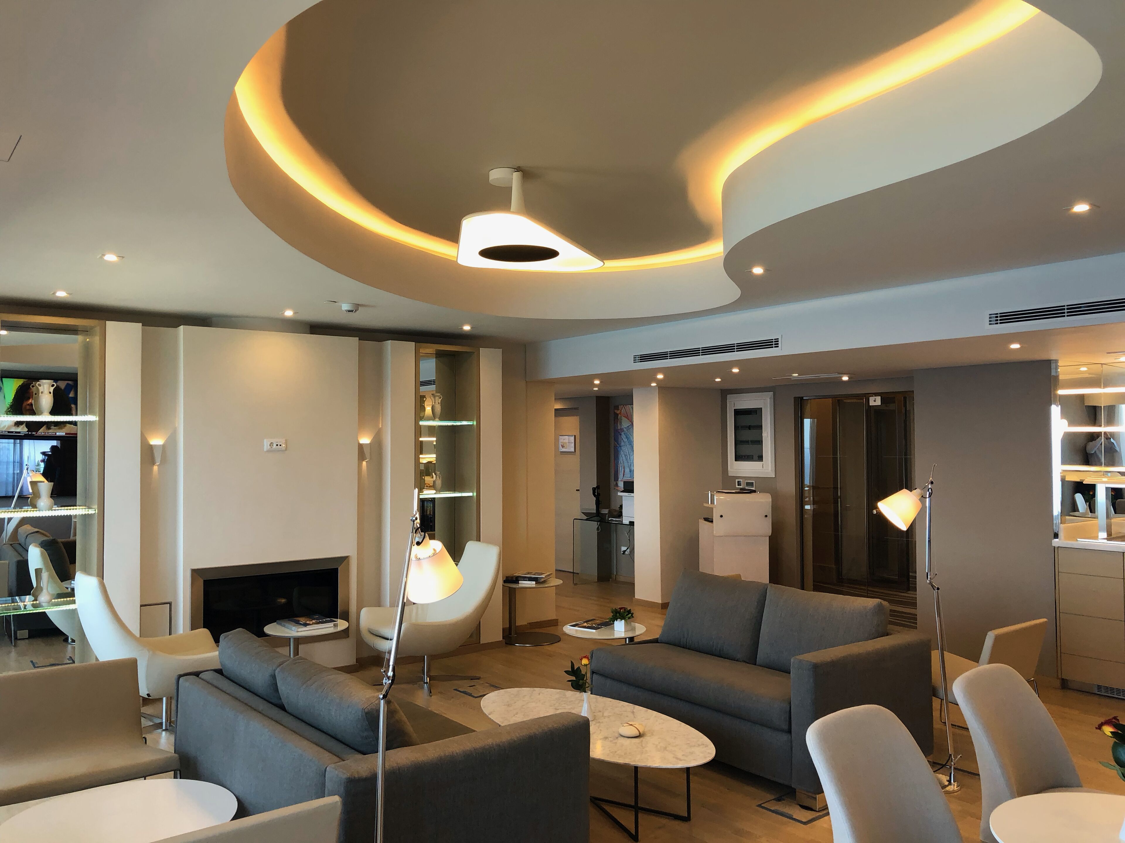 A modern living room with sofas, a coffee table, and a fireplace.