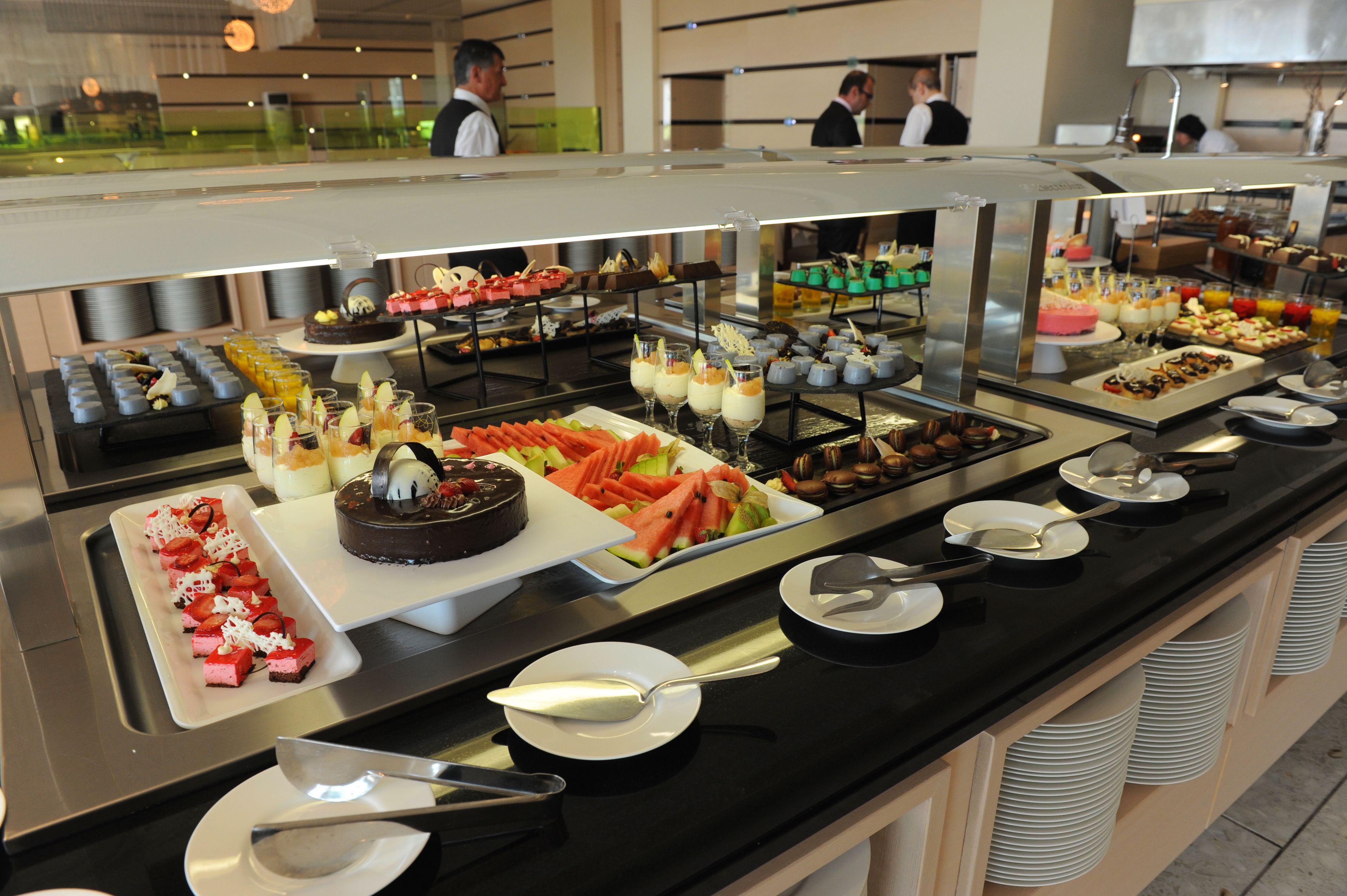 A buffet with various food items and utensils.