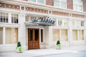 A building with a sign reading "the ashton" above the entrance. - The Ashton Hotel (Fort Worth)