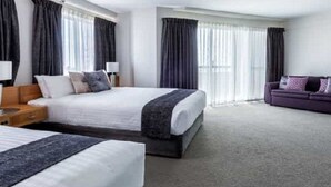 A hotel room with two beds, a sofa, and a large window with curtains. - Best Western Plus Hotel Lord Forrest (Bunbury)