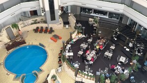 A multi-level indoor pool area with various seating arrangements and a bar/lounge area. - Best Western Plus Hotel Lord Forrest (Bunbury)