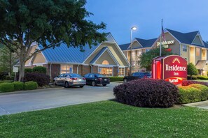 A hotel with a large sign, multiple parking spaces, and a well-maintained lawn. - Residence Inn by Marriott Monroe (Monroe)