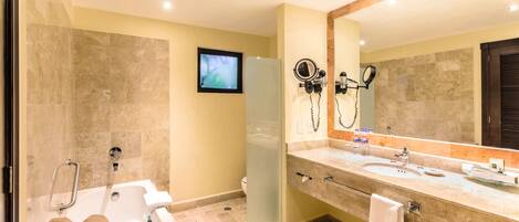 A modern bathroom with a bathtub, a large mirror, and a vanity with a sink.