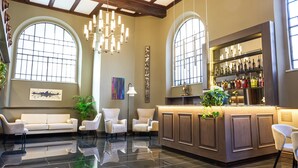 A lobby with a reception desk, seating area, and a bar. - Hotel Viminale (Rome)