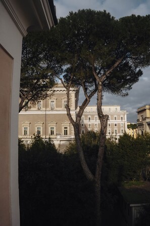 A building with classical architecture, featuring a symmetrical facade, multiple windows, and a balcony.
