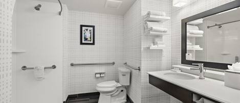 Un baño moderno con ducha, inodoro y lavamanos.