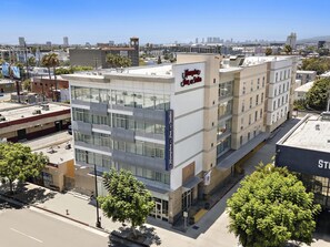 A multi-story hotel with a prominent sign for Hampton Inn & Suites. - Hampton Inn & Suites Los Angeles/Hollywood (Los Angeles)