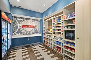A snack and treat section with a variety of products on shelves and a wall display.