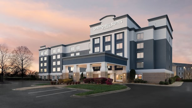 A modern hotel with a large entrance, multiple floors, and a well-maintained lawn. - SpringHill Suites by Marriott Charlotte Concord Mills Spdwy (Concord)