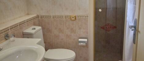 A bathroom with a sink, toilet, and shower.