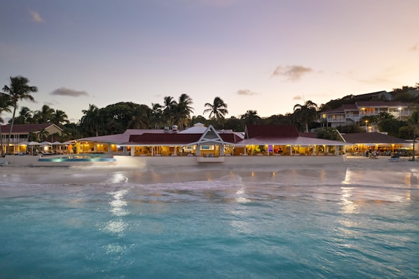 On the beach, white sand, sun-loungers, beach umbrellas