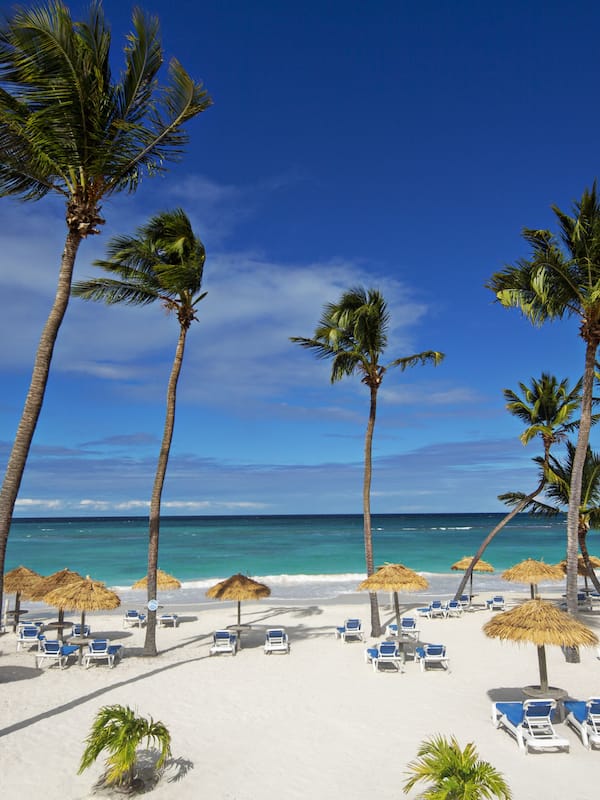On the beach, white sand, sun loungers, beach umbrellas