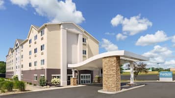A multi-story hotel with a modern design, featuring a covered entrance and a sign indicating it is a Marriott property.